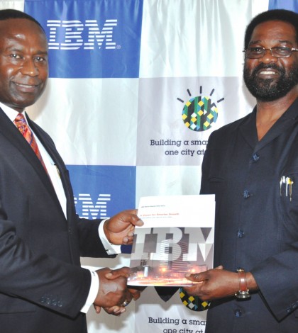 Joe Mensah, Country General Manager, IBM Ghana (left) presents an IBM Smarter Cities report on Accra, Ghana to the city's Mayor, Alfred Vanderpujie. (PRNewsFoto/IBM)